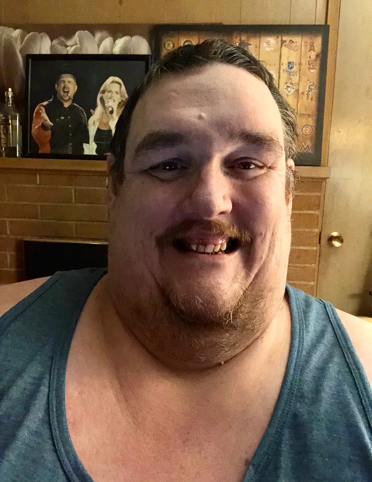 Ken in a blue tank top in 2021